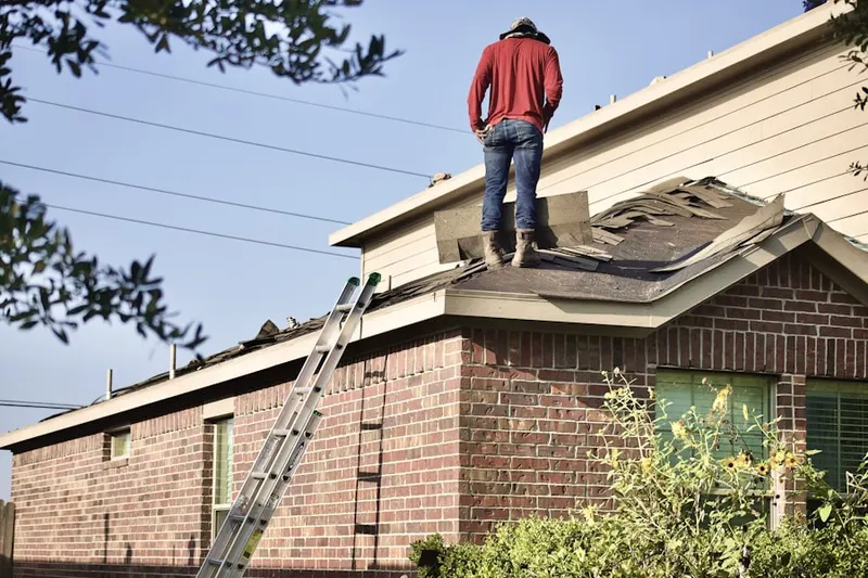 Professional roofer working on a residential roof in Union Settlement